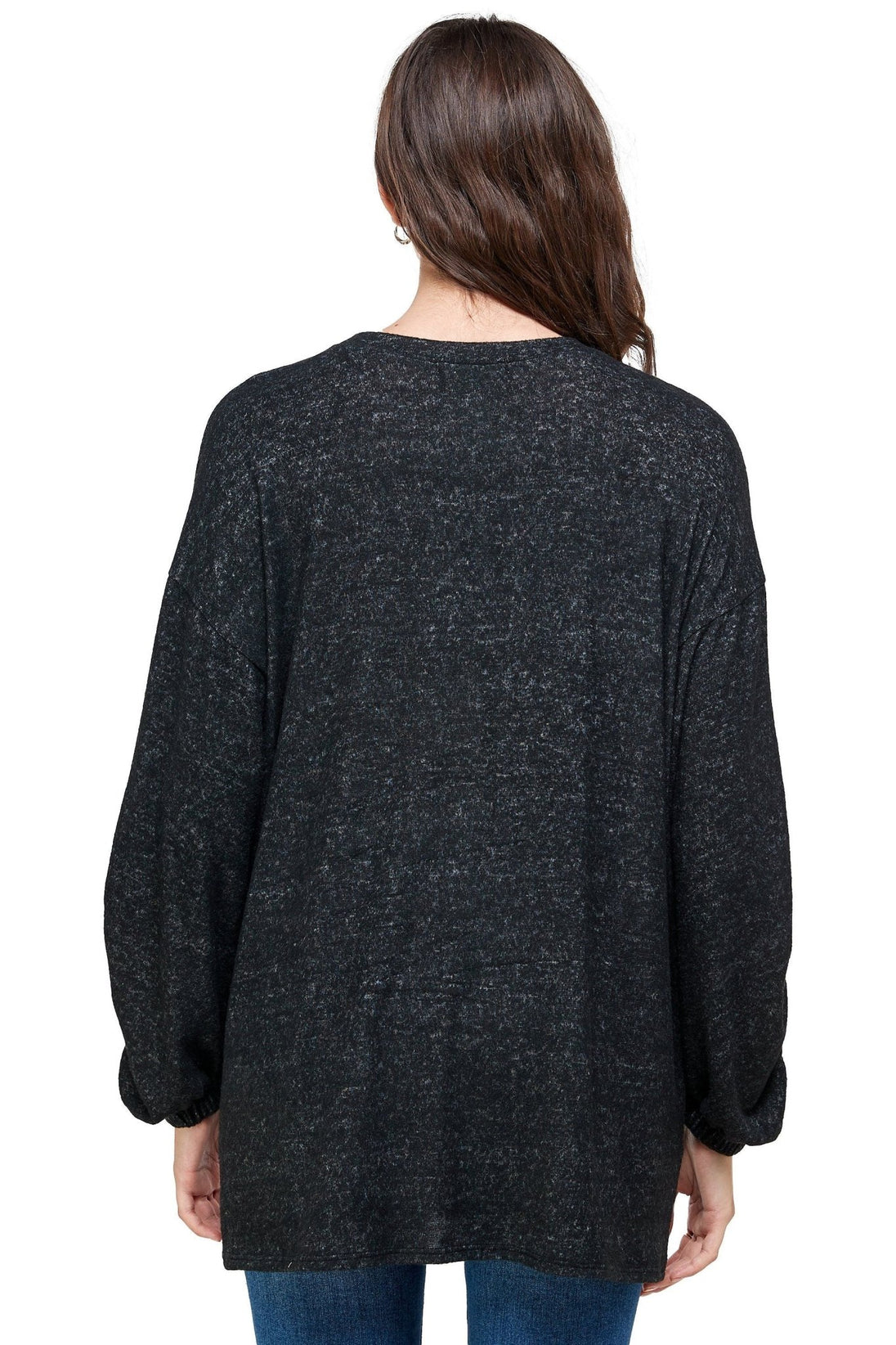 Person wearing a dark gray cardigan on a white background