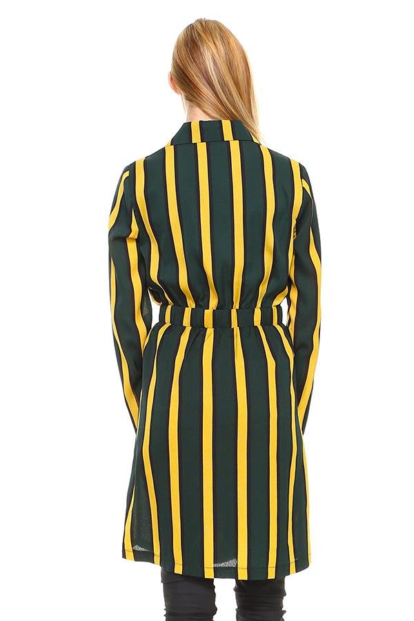 Woman wearing a green and yellow striped dress on a white background