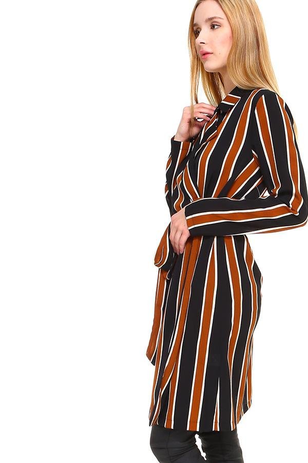 Woman wearing a black and orange striped dress on a white background