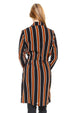 Woman wearing a black and orange striped dress with a white background