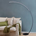 Modern curve floor lamp used as home decor lighting in stylish living room
