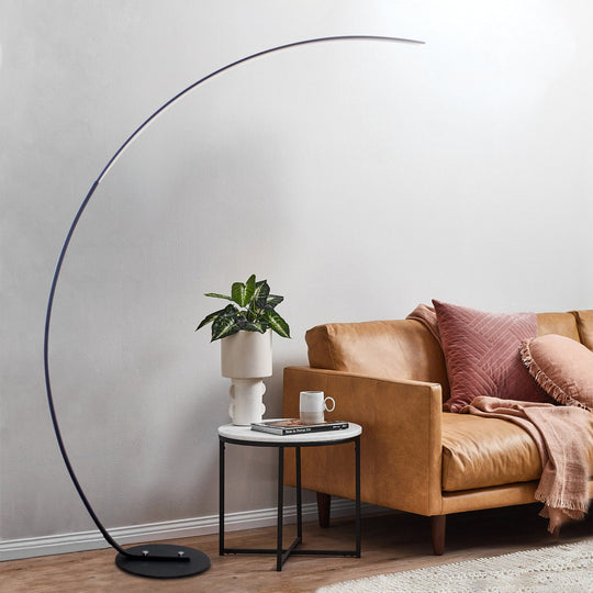 Modern curve floor lamp used as home decor lighting in stylish living room interior