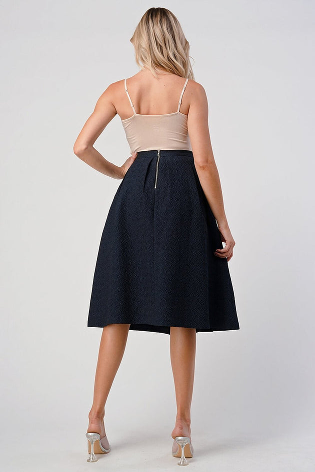 Pleated A-Line Midi Skirt – Pleated Textured Everyday Elegance shown from the back, highlighting its high-waisted design and elegant movement.