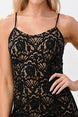Black lace dress worn by a person on a plain background