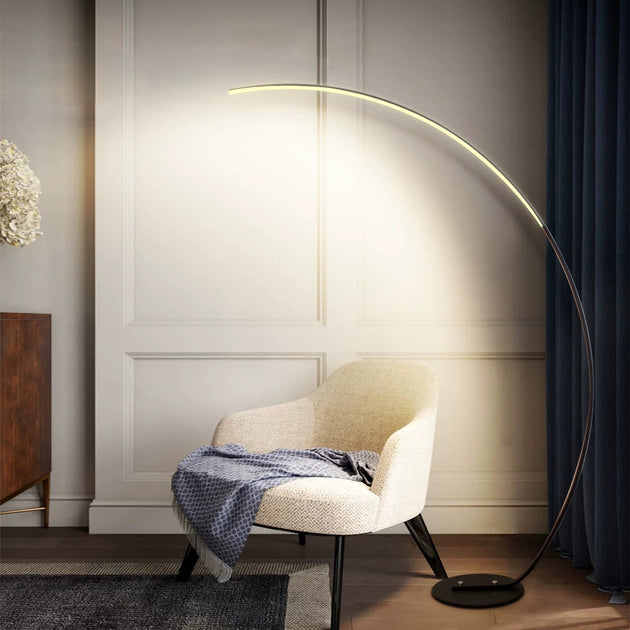 Modern curve floor lamp used as home decor lighting in stylish living room interior