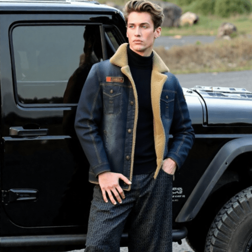 Man standing next to a black SUV wearing a denim jacket with a fur - lined hood.