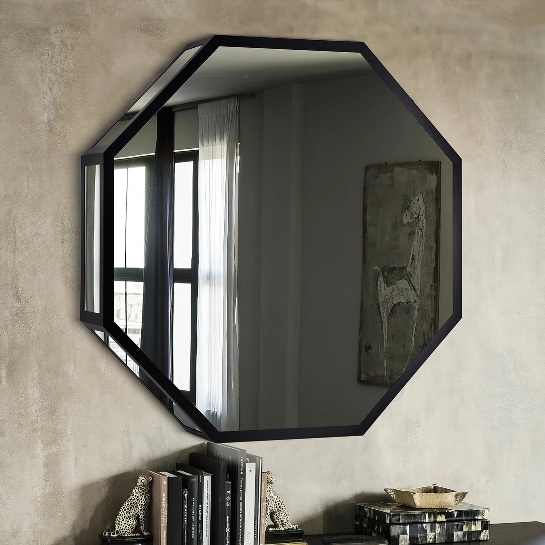 Octagonal mirror with black frame on a textured wall