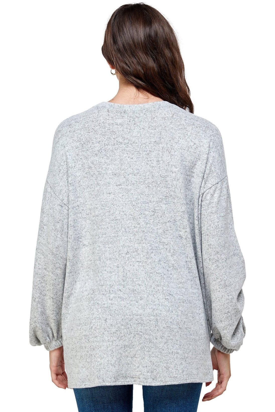 Person wearing a gray sweater on a white background