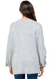 Person wearing a gray sweater on a white background