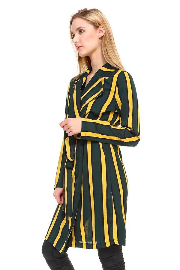 Woman wearing a green and yellow striped dress on a white background