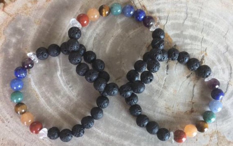 Handmade aromatherapy chakra diffuser bracelet with genuine gemstones and black lava beads.