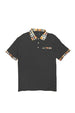 Black polo shirt with plaid collar and sleeve trim on a white background