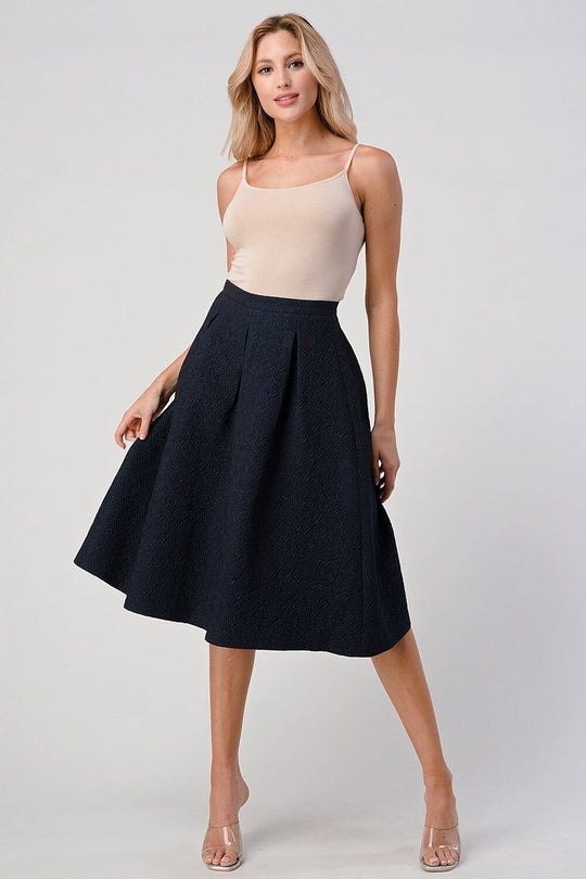 Pleated A-Line Midi Skirt – Pleated Textured Everyday Elegance worn by a model in a stylish pose, showcasing its flattering silhouette.