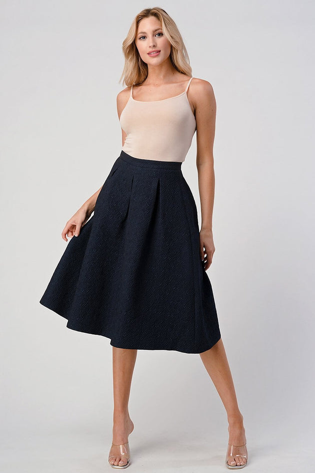 Pleated A-Line Midi Skirt – Pleated Textured Everyday Elegance worn by a model in a stylish pose, showcasing its flattering silhouette.