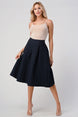 Pleated A-Line Midi Skirt – Pleated Textured Everyday Elegance worn by a model in a stylish pose, showcasing its flattering silhouette.