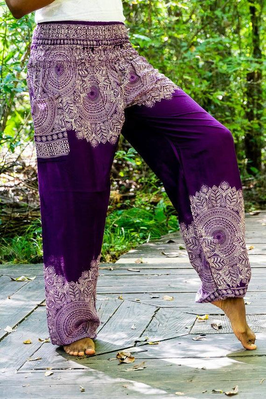 Purple floral boho harem pants worn in forest setting