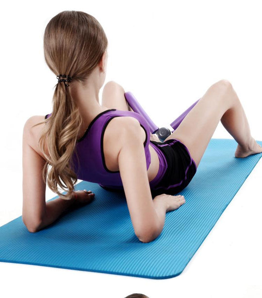 Woman exercising on a blue mat with a white background